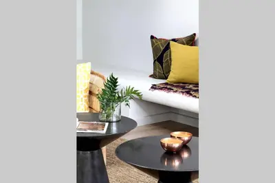 a living room with a couch and a table at McFarlane Residence by Top Destinations Rentals in Hermanus
