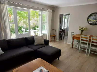 a living room with a black couch and a table at At Leisure in Worcester
