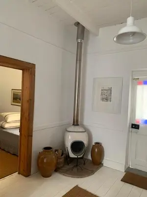 a room with a stove in the corner of a room at The Missions House in Hermanus