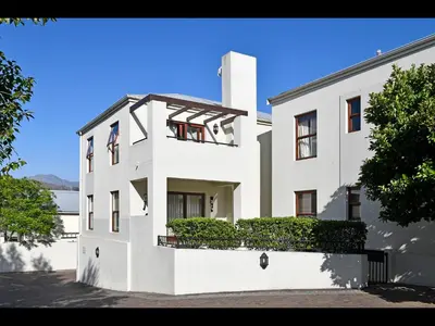 a white house with a fence in front of it at Sorbonne 1 - No loadshedding in Franschhoek