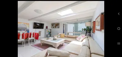 a living room with a couch and a table at Antilles on Beach in Cape Town