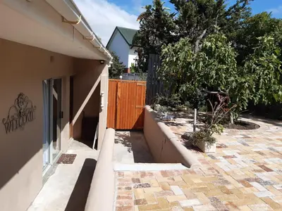 a side view of a house with a fence at Goedehoop in Somerset West