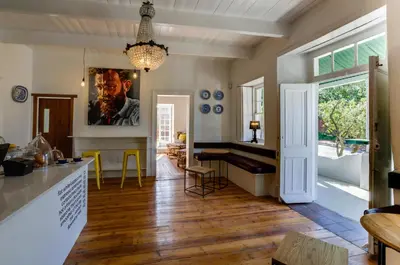 a kitchen with a dining area and a dining table at The Post House Hotel - no children under the age of 16yrs in Greyton