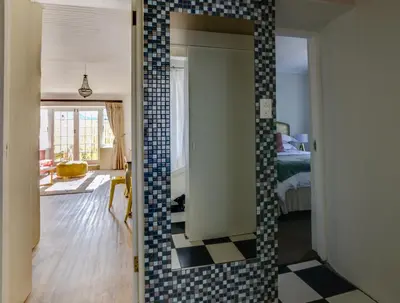 a room with a mirror with a tile wall at The Post House Hotel - no children under the age of 16yrs in Greyton