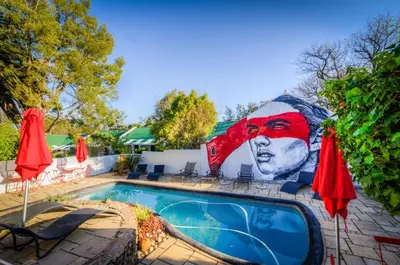 a mural on the side of a building with a pool at The Post House Hotel - no children under the age of 16yrs in Greyton