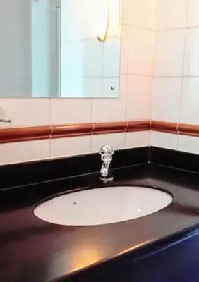 a bathroom with a sink and a mirror at OCEANPEARL 209 in Strand