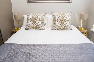a bedroom with a white bed with pillows at Apartment Claudia in Stellenbosch