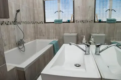 a bathroom with two sinks and two toilets at Apartment Claudia in Stellenbosch