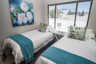 a bedroom with two beds and a window at Apartment Claudia in Stellenbosch