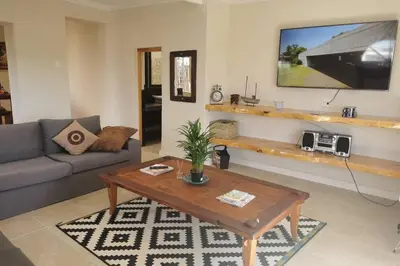 a living room with a couch and a coffee table at The Blue Horizon House - Botrivier in Caledon