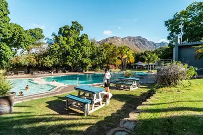a person standing next to a pool at a resort at ATKV Goudini Spa in Rawsonville