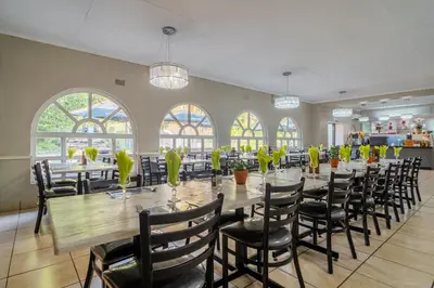 a large dining room with a long table and chairs at ATKV Goudini Spa in Rawsonville