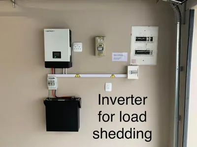 a wall with a sign that reads inverter for load shedding at House Vos in Hermanus