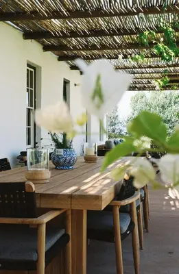 a wooden table with chairs and a table with a plant at Eikehof Farm in Worcester