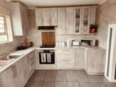 a kitchen with a stove and a sink in it at Sir James Self Catering in Cape Town