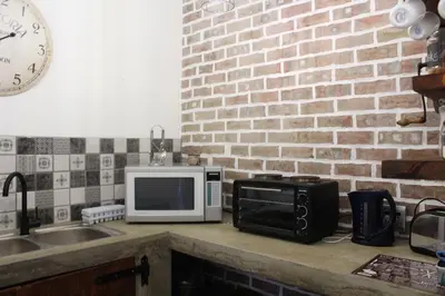 a kitchen counter with a microwave and a toaster oven at 19 on Micro Avenue in Strand