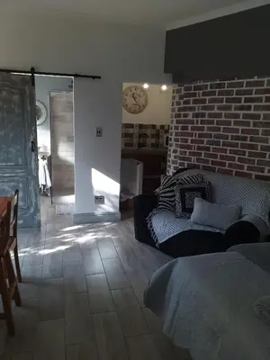 a living room with a couch and a brick wall at 19 on Micro Avenue in Strand