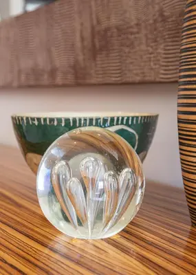 a glass bowl filled with spoons sitting on a table at Marine Square Luxury Suites in Hermanus