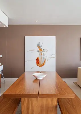 a wooden table in a room with a painting at Marine Square Luxury Suites in Hermanus