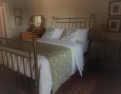 a bedroom with a large bed with white pillows at La Rochelle in Wellington