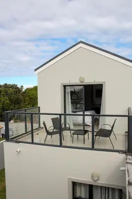 a balcony with chairs and a table on a house at Elizabeth House in Hermanus