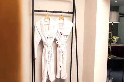 a closet with a robe on a rack at Franschhoek Maison du Cap in Franschhoek