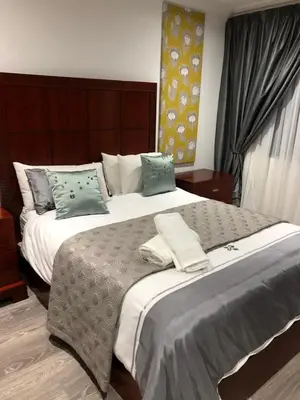 a bedroom with two beds with pillows on them at Spoelklippies in Hermanus