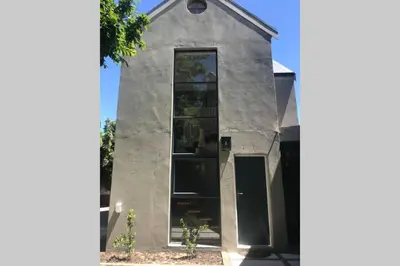 a house with a large window on the side of it at Comfortable Room with Large en suite Bathroom in Franschhoek