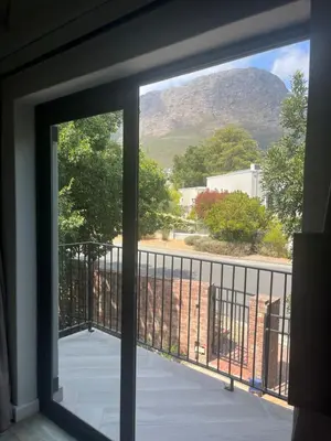 a window with a view of a mountain view at Comfortable Room with Large en suite Bathroom in Franschhoek