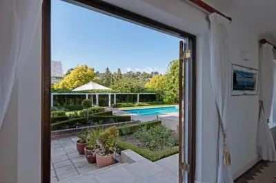 a view of a pool from a window of a house at Die Rietdak - Reetdachhaus mit vier Schlafzimmern in Cape Town
