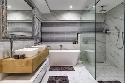 a bathroom with a tub and a sink and a shower at Villa de luxe in Franschhoek