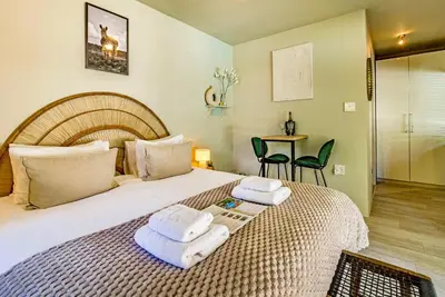 a bedroom with a large bed with towels on it at Villa Helderberg in Somerset West