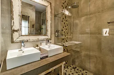 a bathroom with two sinks and a mirror at Villa Helderberg in Somerset West