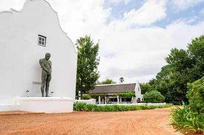 a statue of a man standing in front of a building at Weltevreden Estate in Stellenbosch