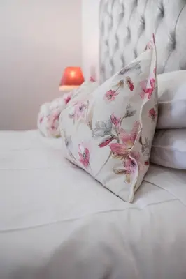 a pillow sitting on top of a bed at Hilltop Guesthouse in Bellville