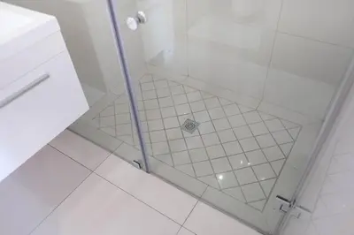 a shower with a glass door in a bathroom at Hilltop Guesthouse in Bellville