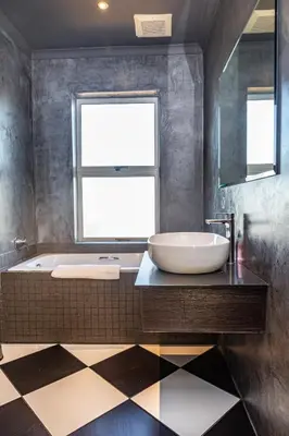 a bathroom with a tub and a sink and a window at Spacious Luxury 3 Bedroom Apartment B401 Sea Spray in Bloubergstrand