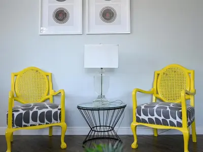 two yellow chairs with a table in a room at Portico 501 / 904 in Cape Town