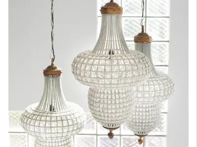 three white glass chandeliers hanging from a wall at Portico 501 / 904 in Cape Town