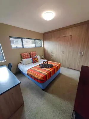 a bedroom with a bed in a room at Karibu Self-catering Accommodation in Hermanus