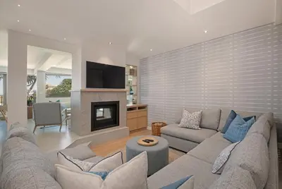 a living room with a couch and a fireplace at Kite View Villa @2 in Cape Town