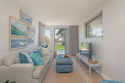 a living room with a couch and a tv at Kite View Villa @2 in Cape Town