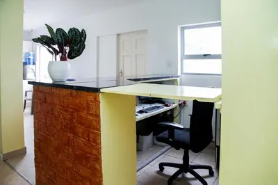 a kitchen with a desk with a potted plant at Relaxing Guest House in th Heart of Ndabeni in Cape Town
