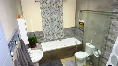 a bathroom with a tub and a toilet and a shower at Sonvanger 2 in Paarl