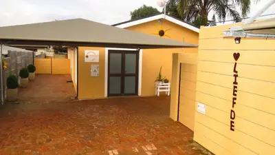 a yellow house with a driveway and a garage at Sonvanger 2 in Paarl