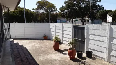 a white fence with potted plants on a patio at MJ ACCOMODATION in Cape Town