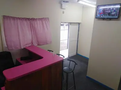 a pink desk in a room with a window at MJ ACCOMODATION in Cape Town