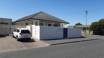 a white car parked in front of a house at MJ ACCOMODATION in Cape Town