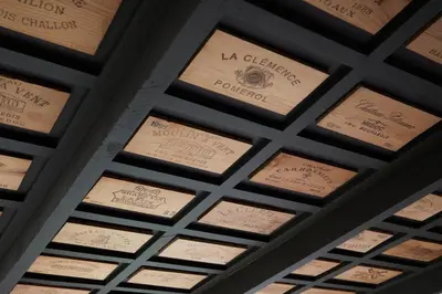 a ceiling filled with wooden boxes with signatures on them at Deux Frères Wine Estate & Luxury Villas in Stellenbosch