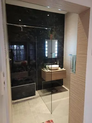 a bathroom with a glass shower and a sink at Perhethian in Cape Town